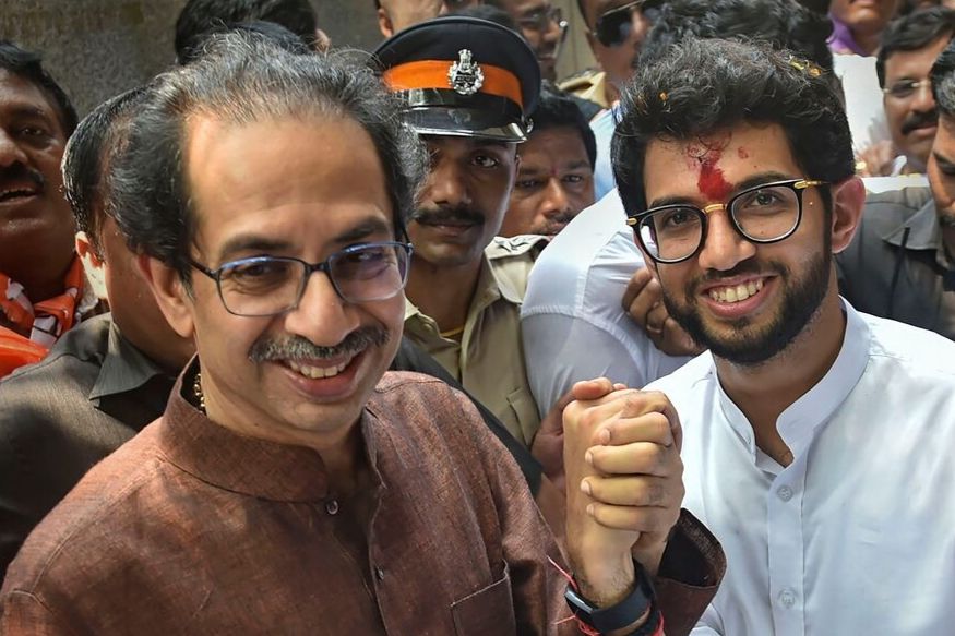 Mumbai: Shiv Sena President Uddhav Thackeray holds the hand of his son and Yuva Sena President Aditya Thackeray, after the former filed his nominations papers from Worli seat for upcoming Maharashtra Assembly elections, in Mumbai, Thursday, Oct. 3, 2019. (PTI Photo/Mitesh Bhuvad)(PTI10_3_2019_000067B)