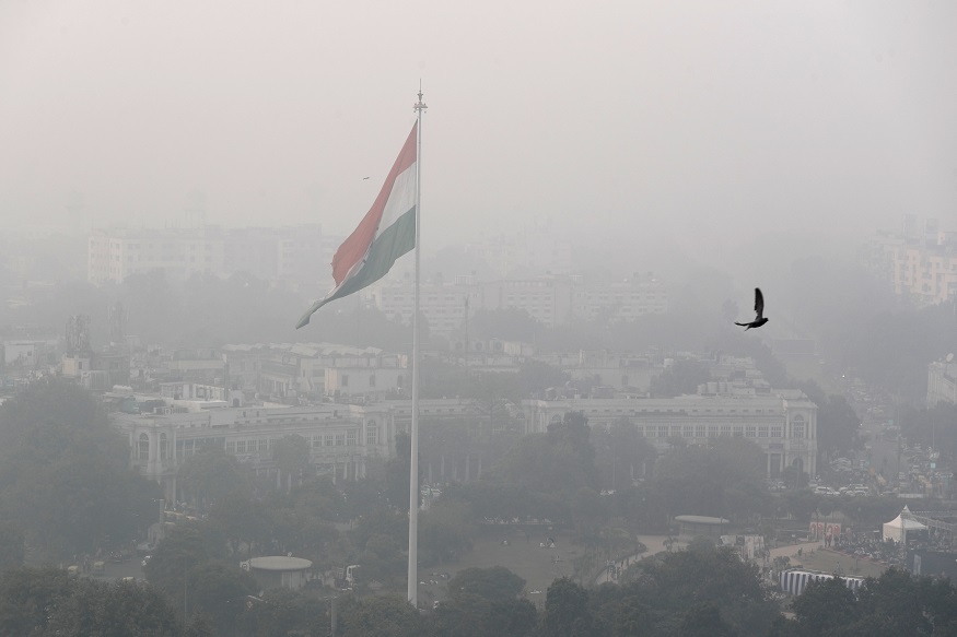 A bird flies past as Delhi's sky line is seen enveloped in smog and dust in New Delhi, India, Friday, Nov. 1, 2019. An expert panel in India's capital has declared a health emergency due to air pollution choking the city, with authorities ordering schools closed until Nov. 5.